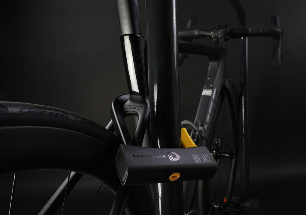 D-lock U-lock secures bike to seat post with bike stand