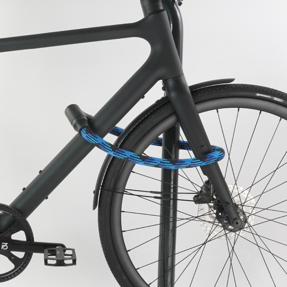 Blue bike lock secures black bike to the down tube and front wheel on the bike stand