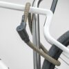 Black and gold texlock orbit textile lock secures several bike parts to the bike stand