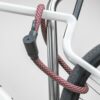 red-gold texlock orbit textile lock secures several bike parts to the bike stand